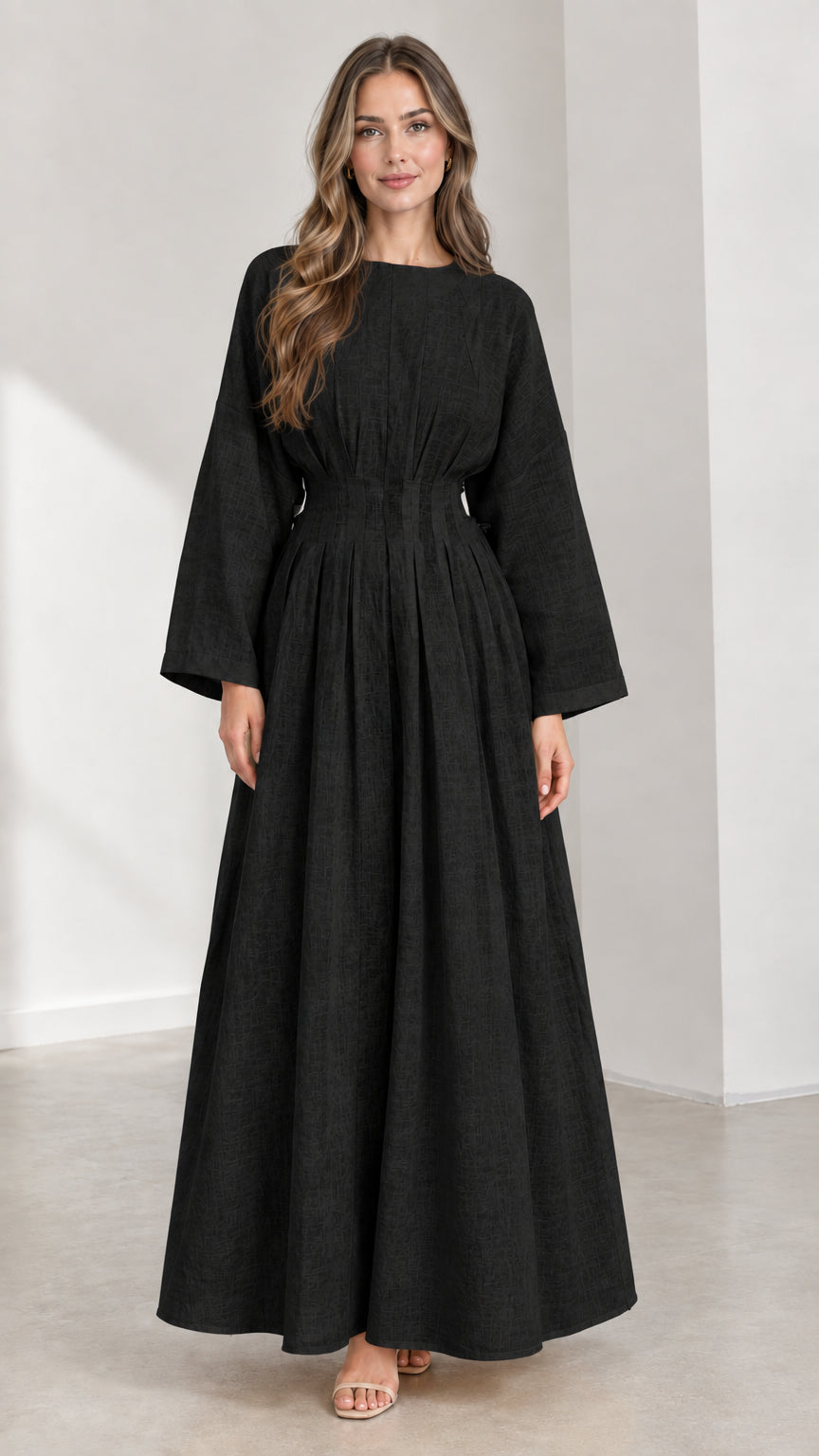 Front view of woman wearing Black pleated waist long sleeve maxi dress