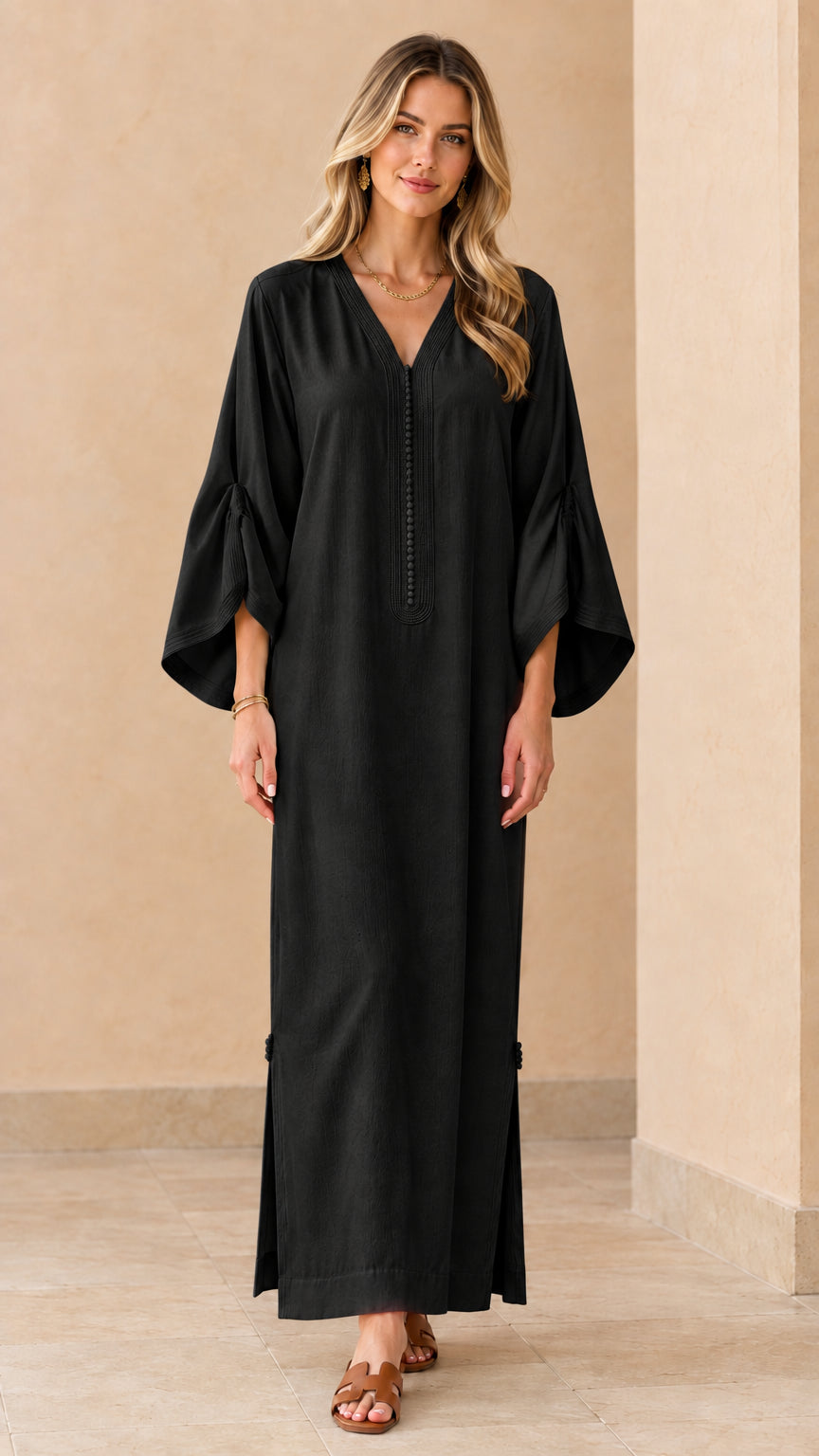 Front view of woman wearing black relaxed bell sleeve kaftan maxi dress