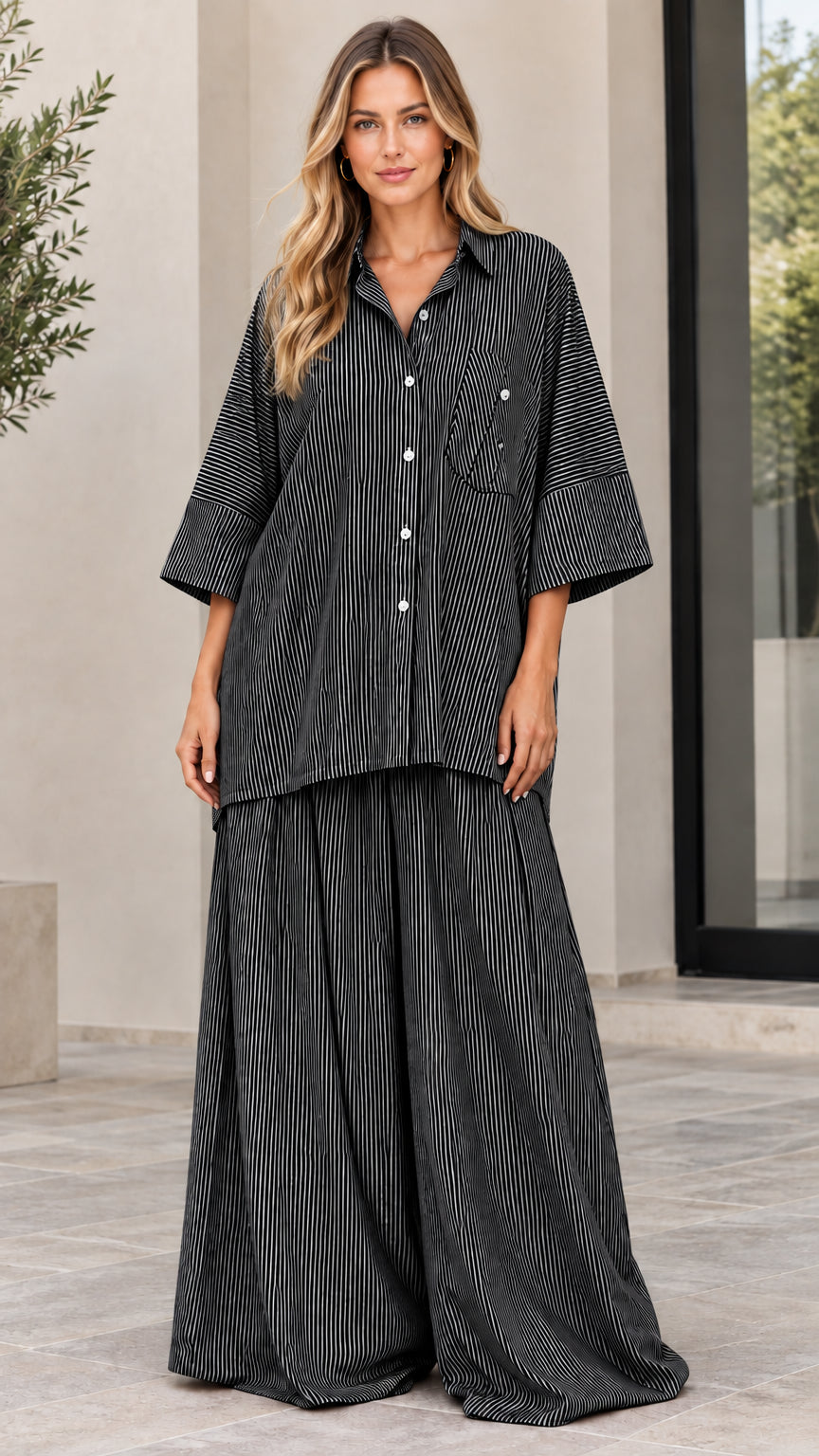 Woman wearing black and white striped matching shirt and pants two-piece set