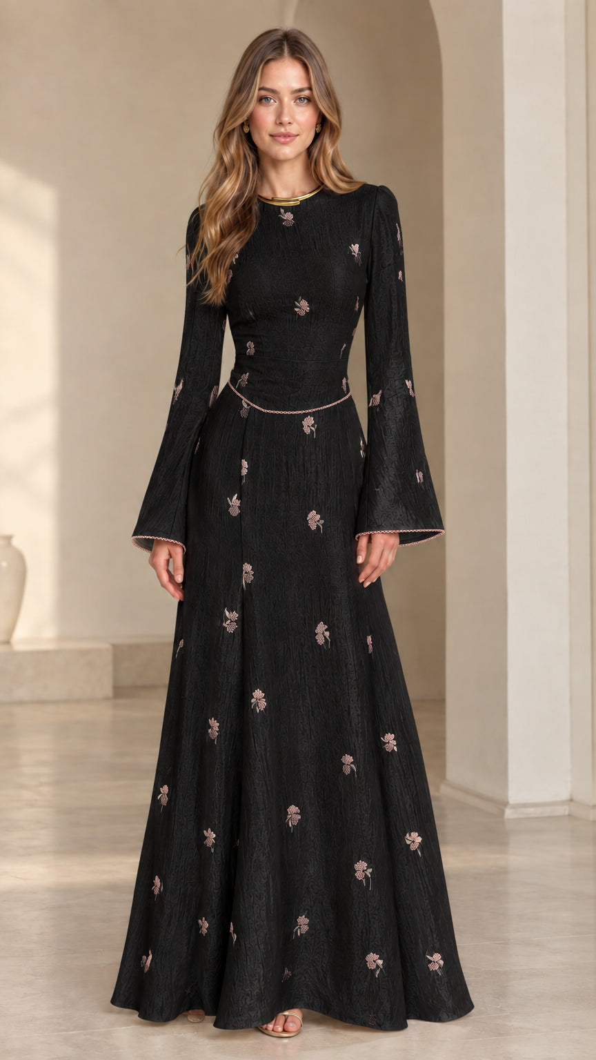 Front view of model wearing black floral jacquard bell sleeve maxi dress