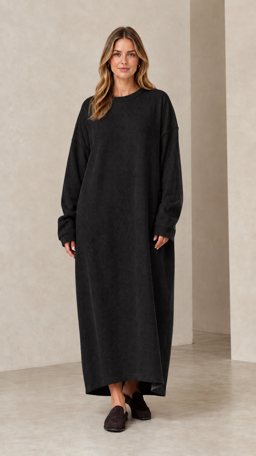 Woman wearing long sleeve black ribbed knit oversized maxi dress