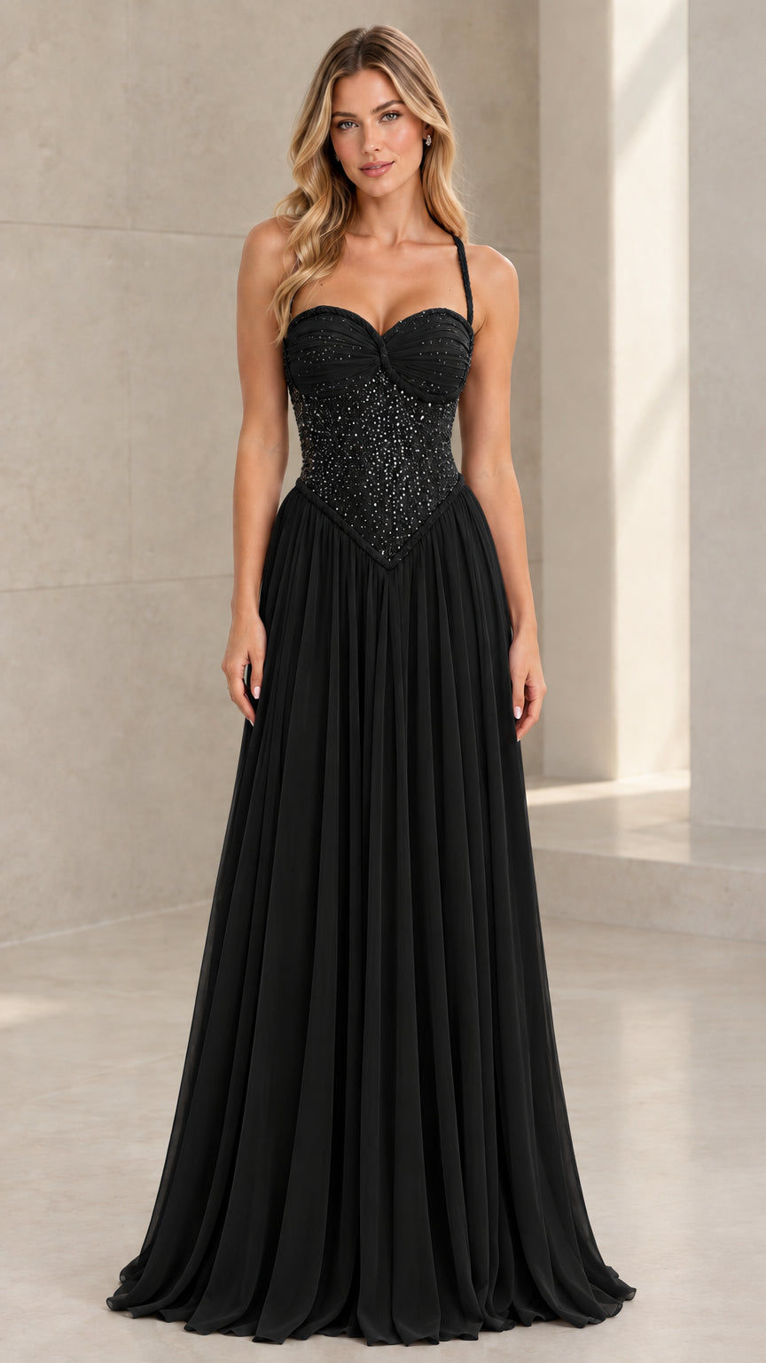 Front view of model wearing Black beaded corset pleated chiffon evening gown
