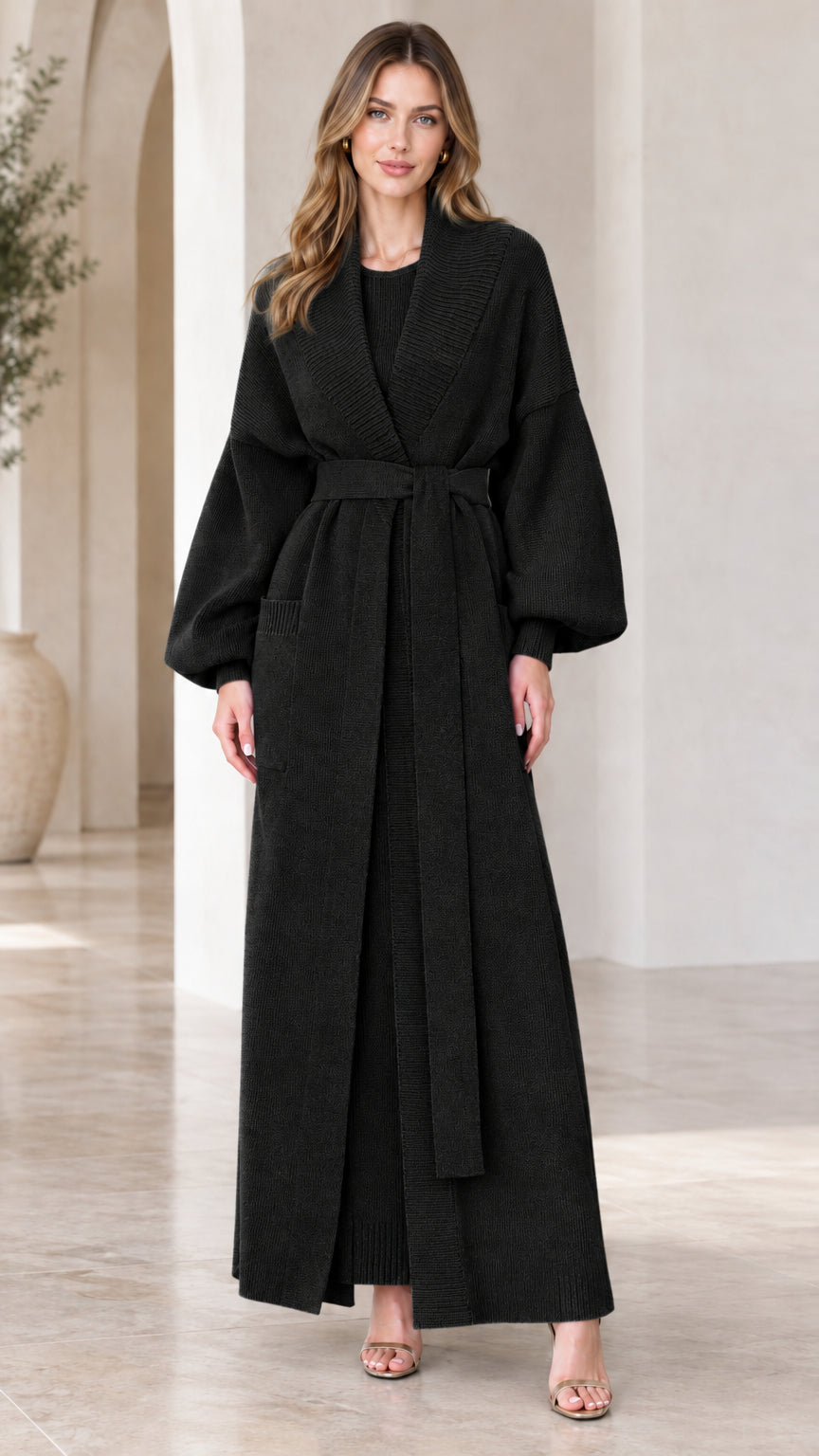 Full-length view of woman wearing black belted maxi knit duster cardigan set