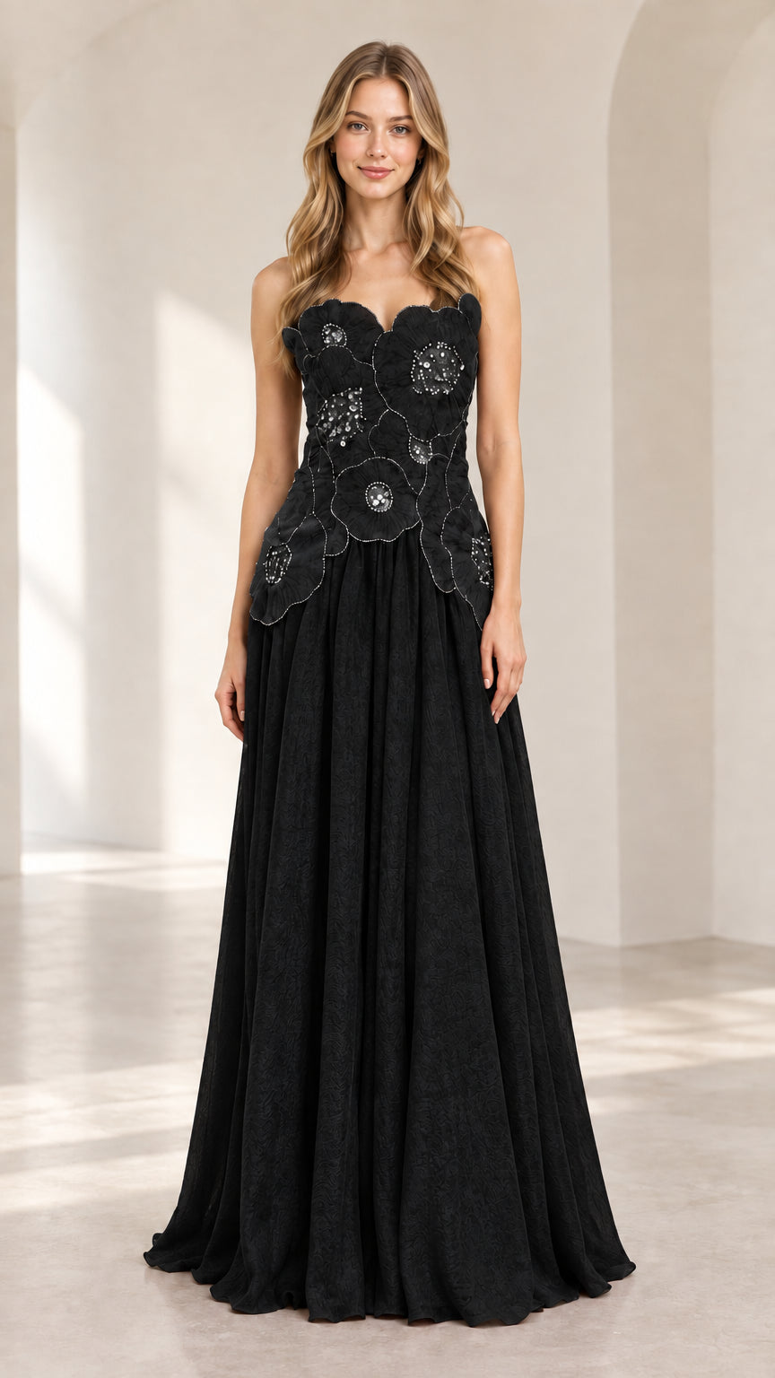 Front view of model wearing black strapless 3D floral chiffon evening gown