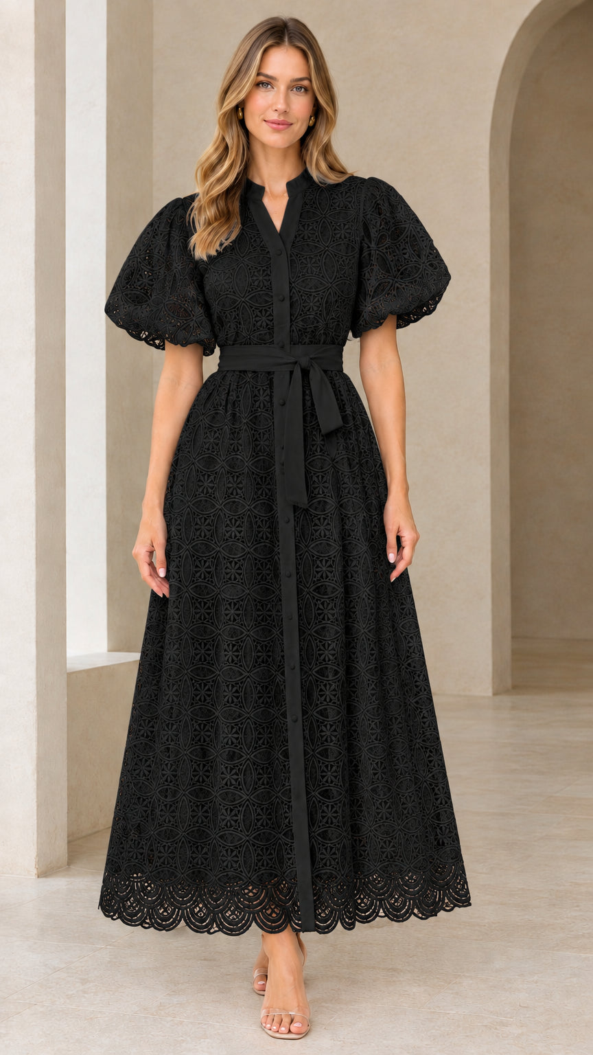 Front view of model wearing black puff sleeve eyelet lace belted maxi dress