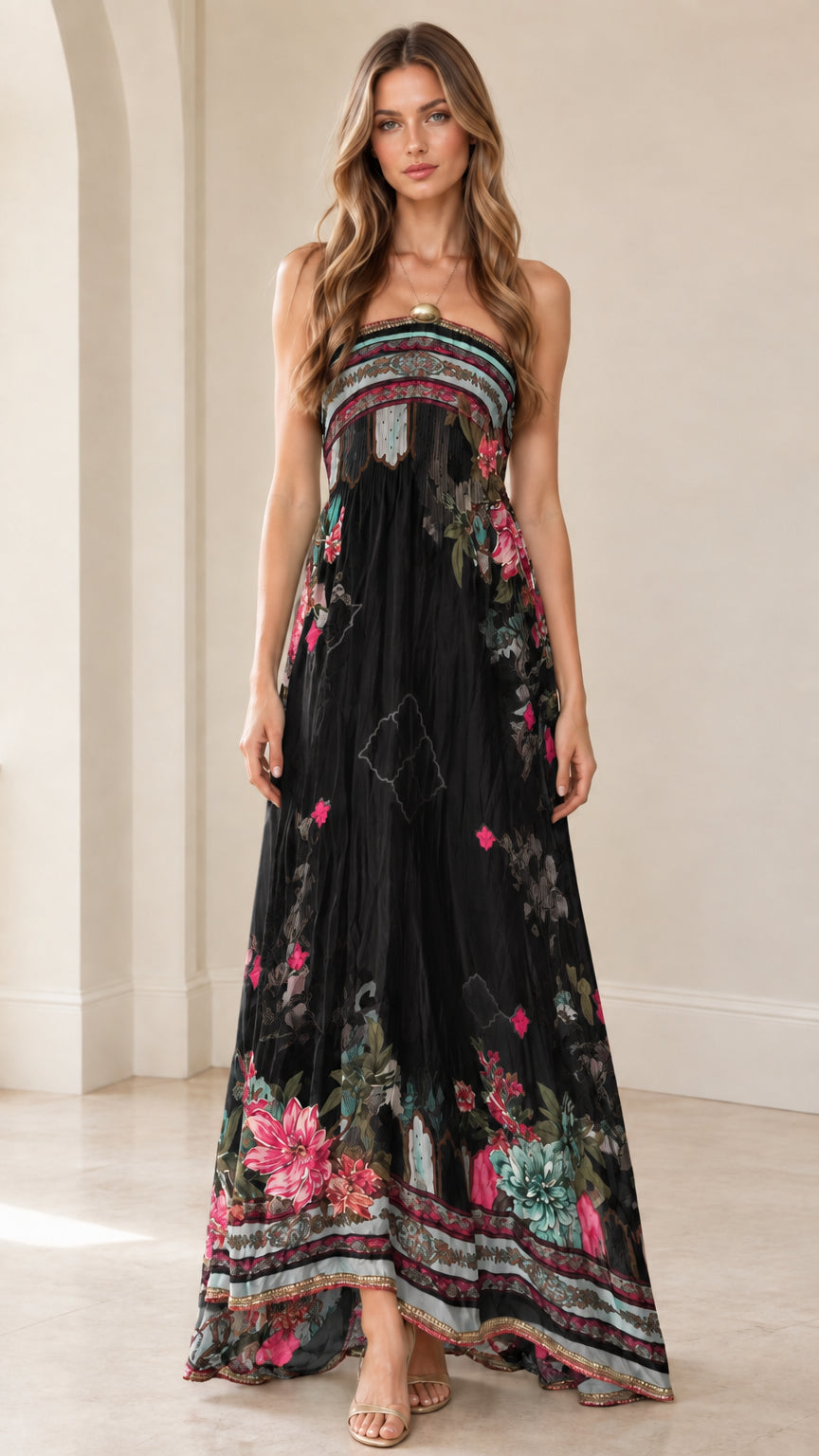 Front view of woman wearing black strapless floral border maxi dress