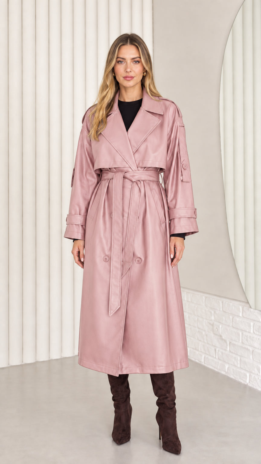 Full-length front view of woman wearing dusty pink faux leather belted trench coat