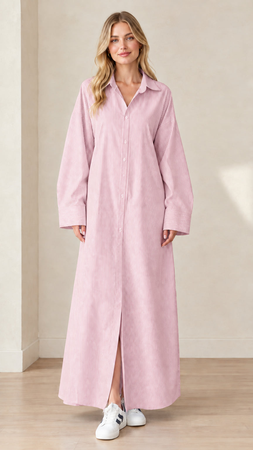 Front view of a model wearing a soft pink and white striped maxi shirt dress