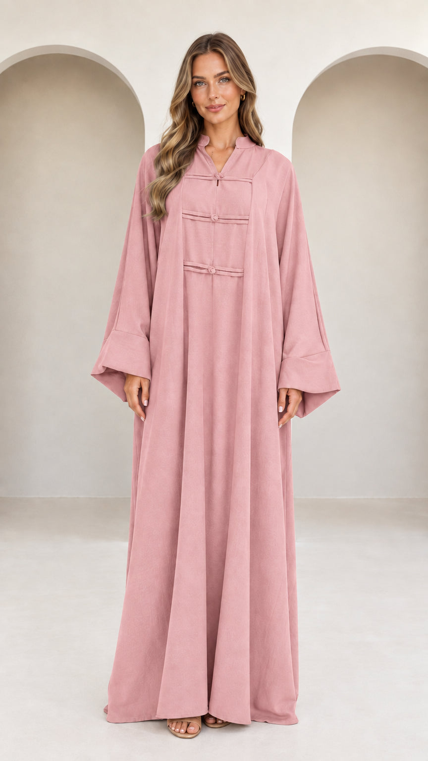 Front view of model wearing dusty pink long sleeve modest abaya dress