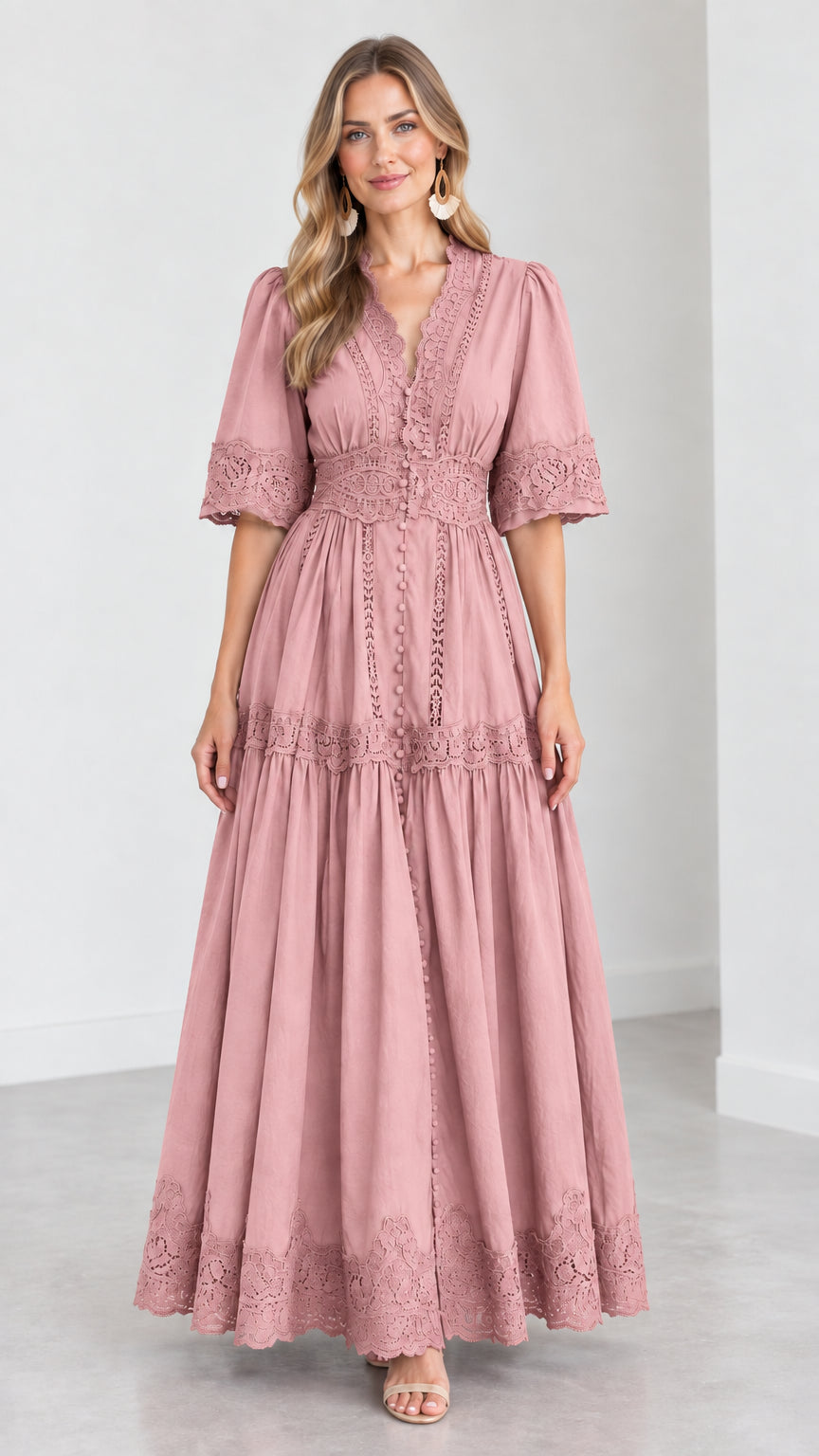 Front view of woman wearing a dusty pink V-neck lace trim tiered maxi dress