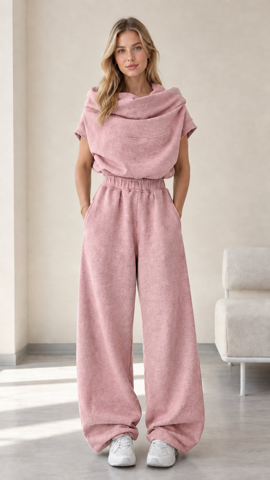 Full-length studio view of model wearing dusty pink cowl neck top and wide-leg pants set