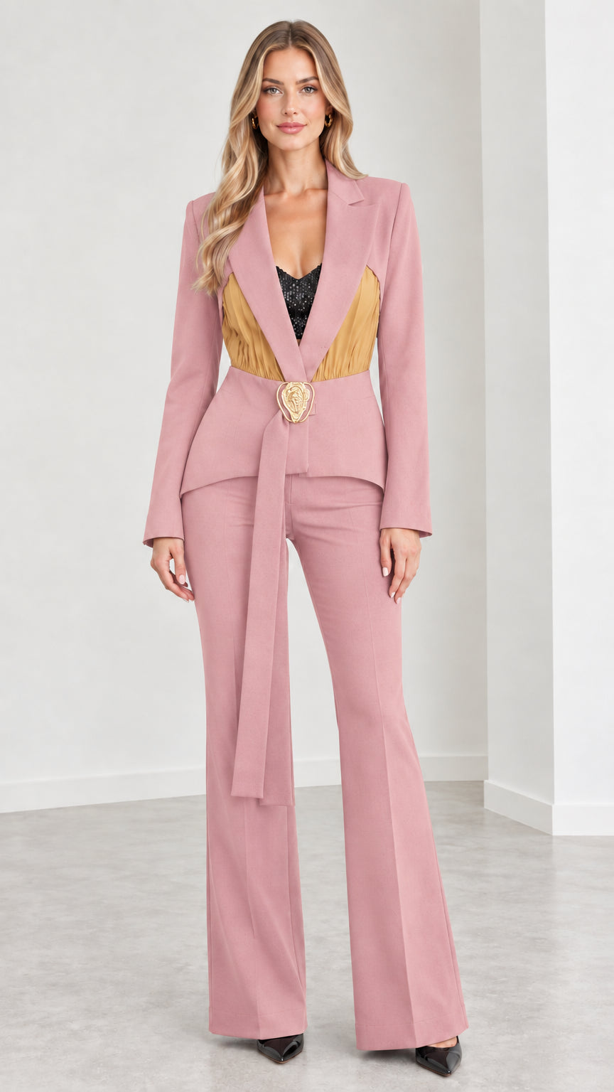 Model wearing dusty pink tailored blazer and flared pant suit set