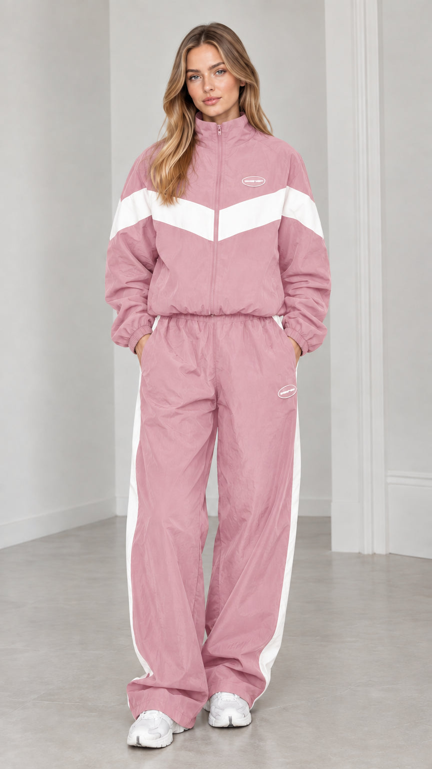Full length view of woman wearing dusty pink and white colorblock tracksuit set