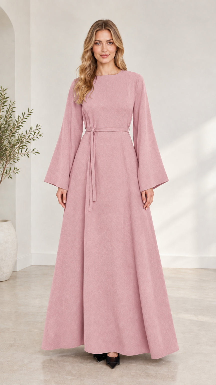 Full-length front view of woman wearing dusty pink long bell sleeve modest maxi dress