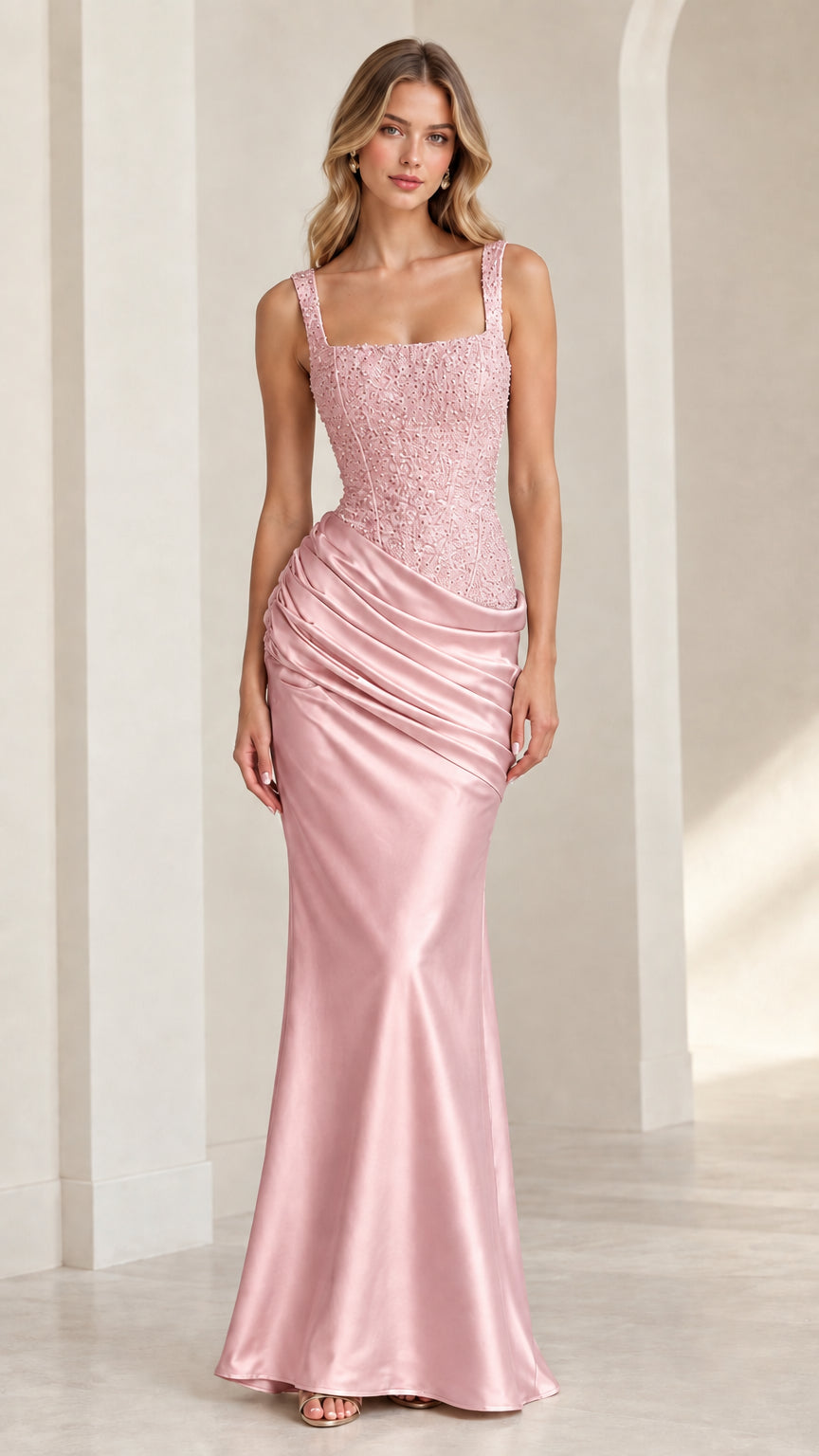 Model posing in blush pink embellished bodice ruched satin maxi dress