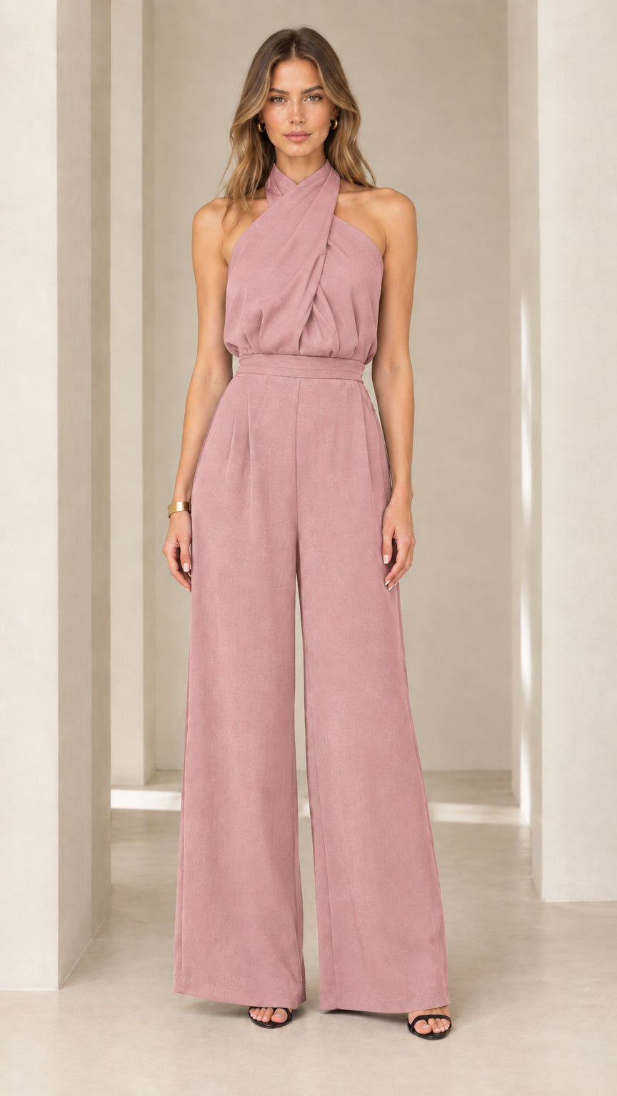 Model wearing dusty pink crisscross halter neck wide-leg jumpsuit