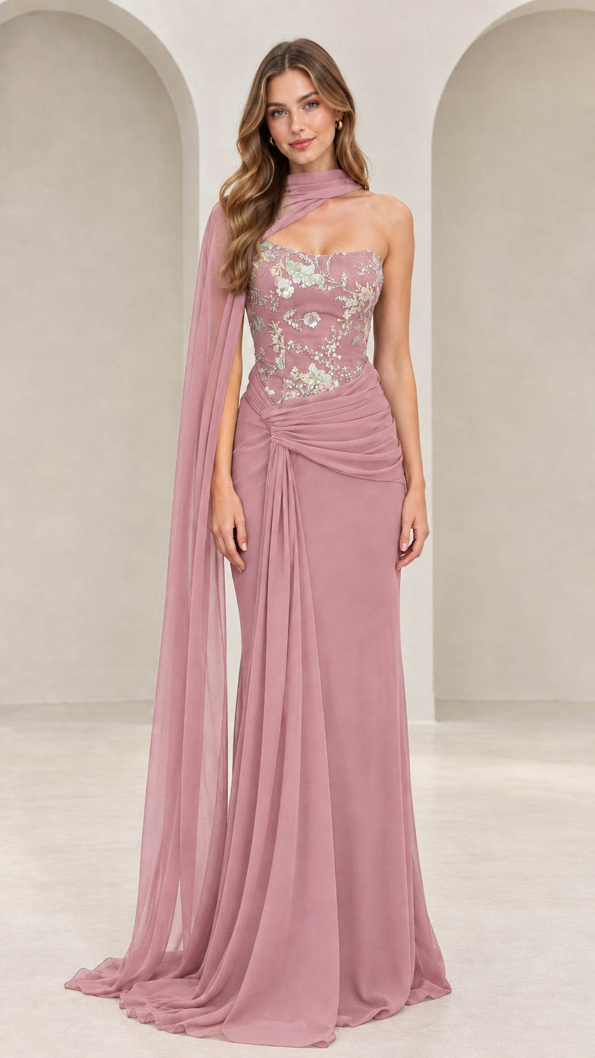 Front view of dusty rose floral embroidered evening gown with asymmetric cape detail
