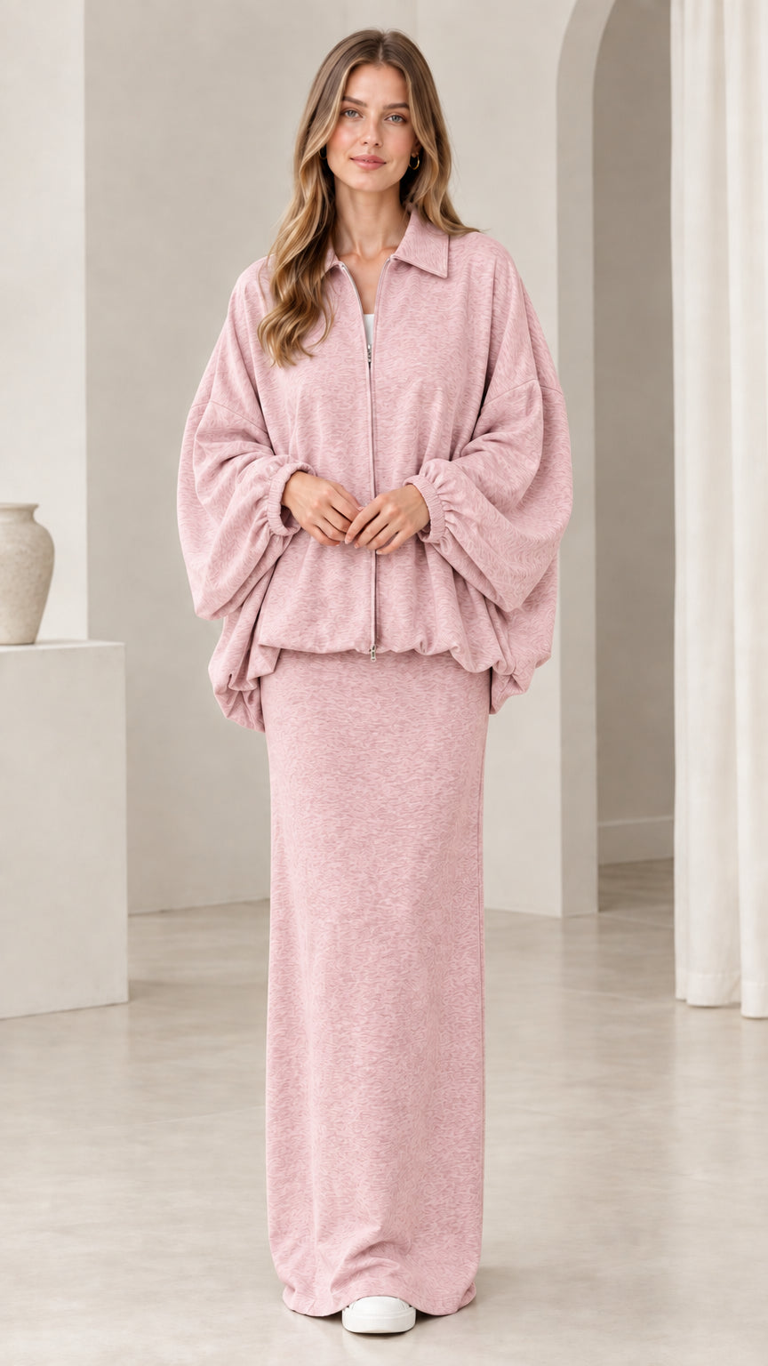 Model wearing dusty pink zip jacket and matching column maxi skirt set
