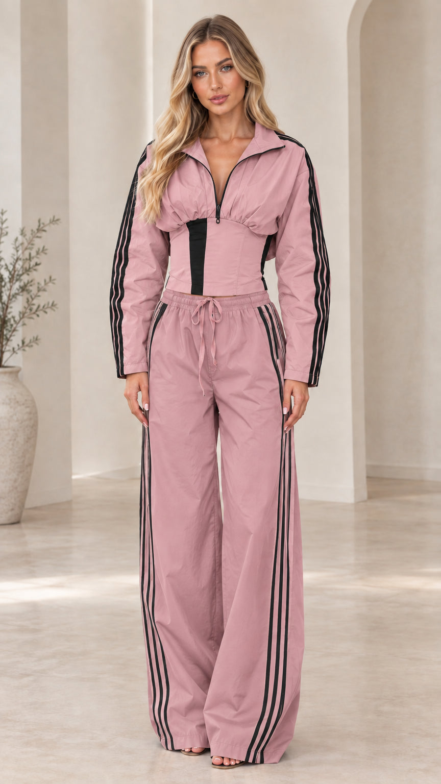 Full-length front view of dusty pink zip-up corset jacket and wide-leg striped pants set