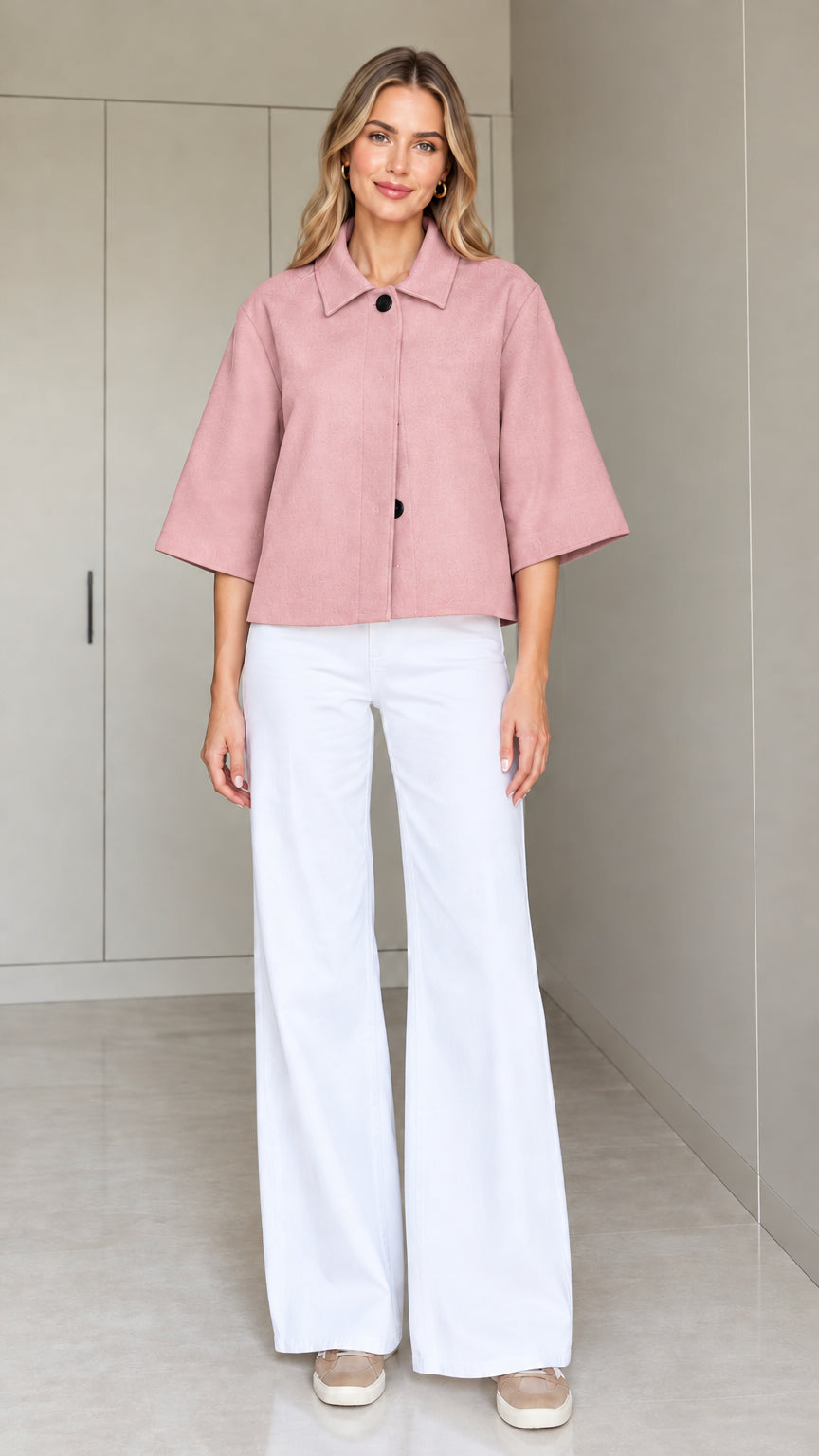 Front view of a woman wearing the cropped half-sleeve swing jacket in dusty pink
