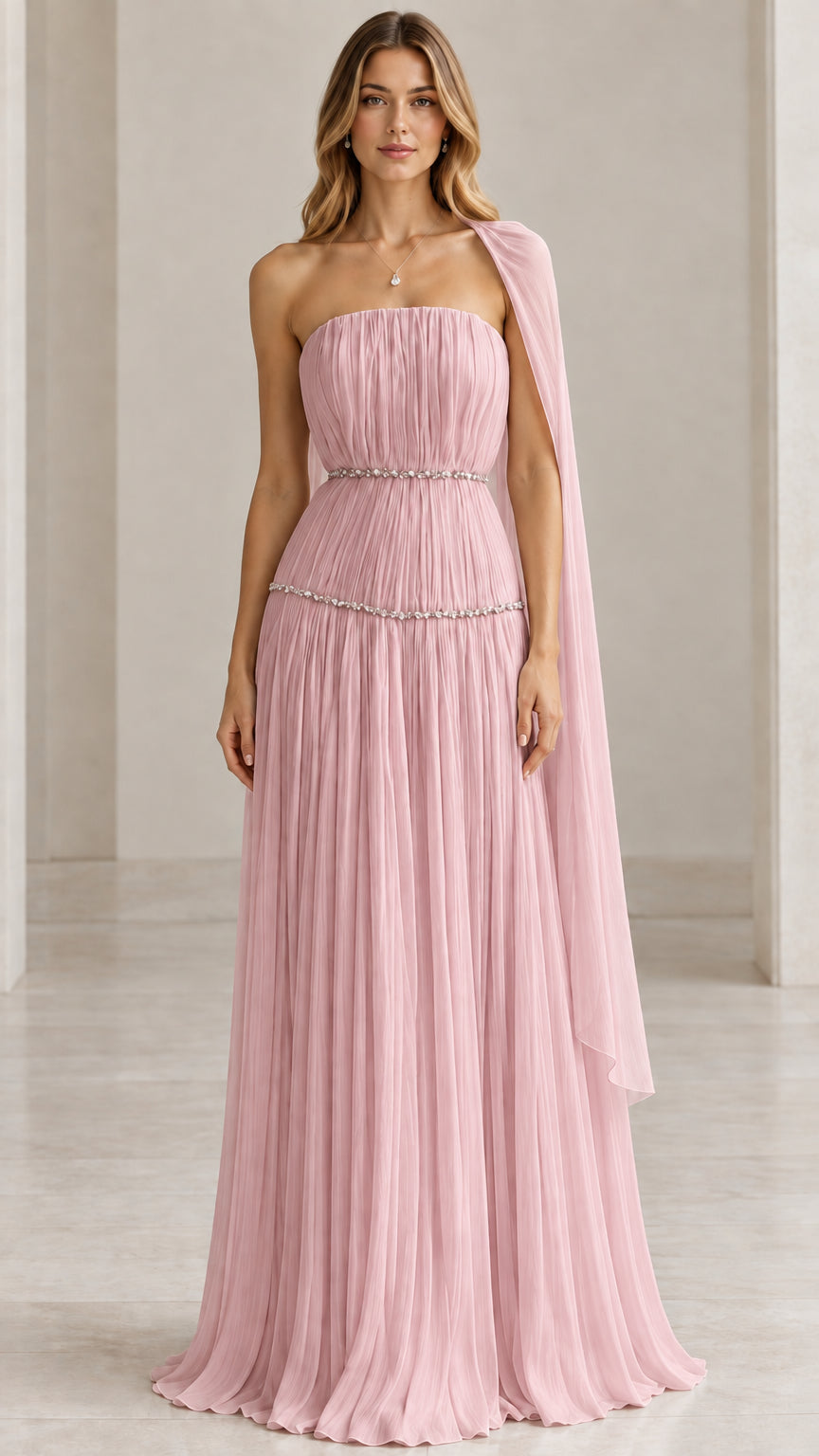 Model wearing dusty pink strapless pleated evening gown with shoulder scarf detail
