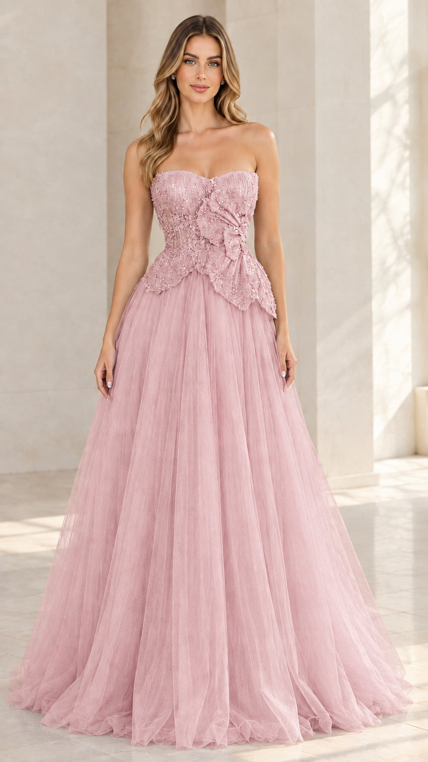Model wearing blush pink strapless beaded tulle ball gown
