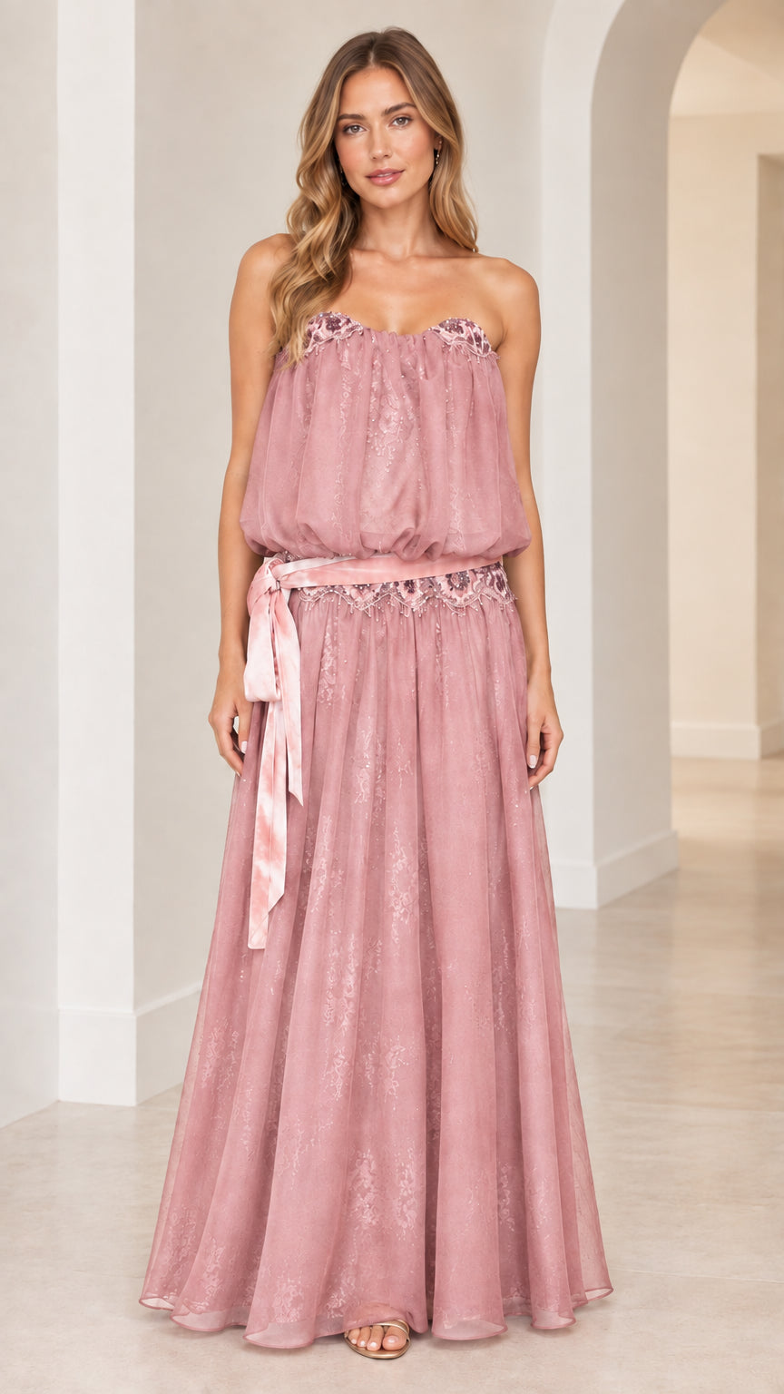 Front view of woman wearing strapless dusty pink blouson maxi dress