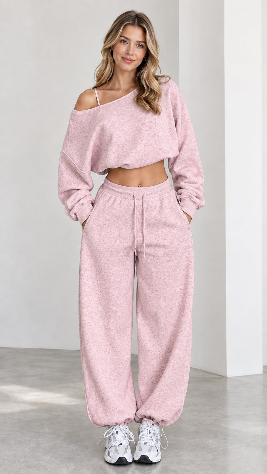 Model wearing dusty pink off-shoulder cropped sweater and wide-leg sweatpants lounge set