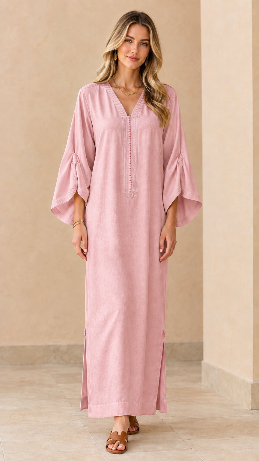 Front view of woman wearing dusty pink flared sleeve kaftan maxi dress