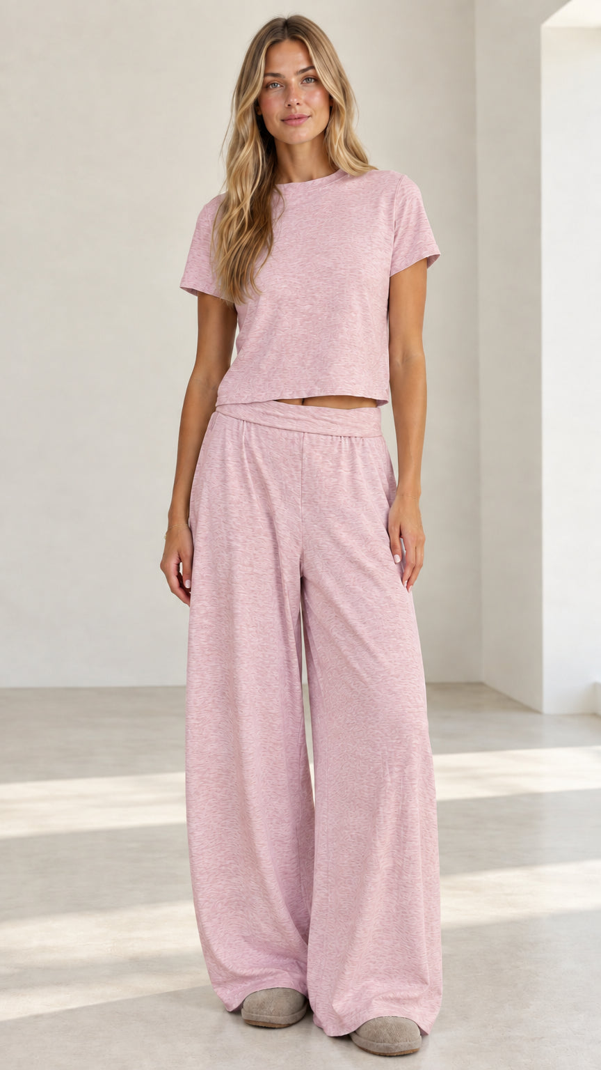 Model wearing heather pink short sleeve crop tee and wide leg pants loungewear set