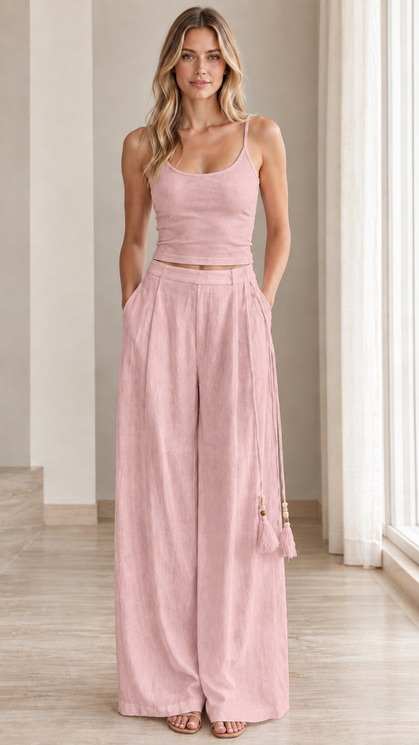 Front view of model wearing dusty pink matching crop top and wide leg pants set
