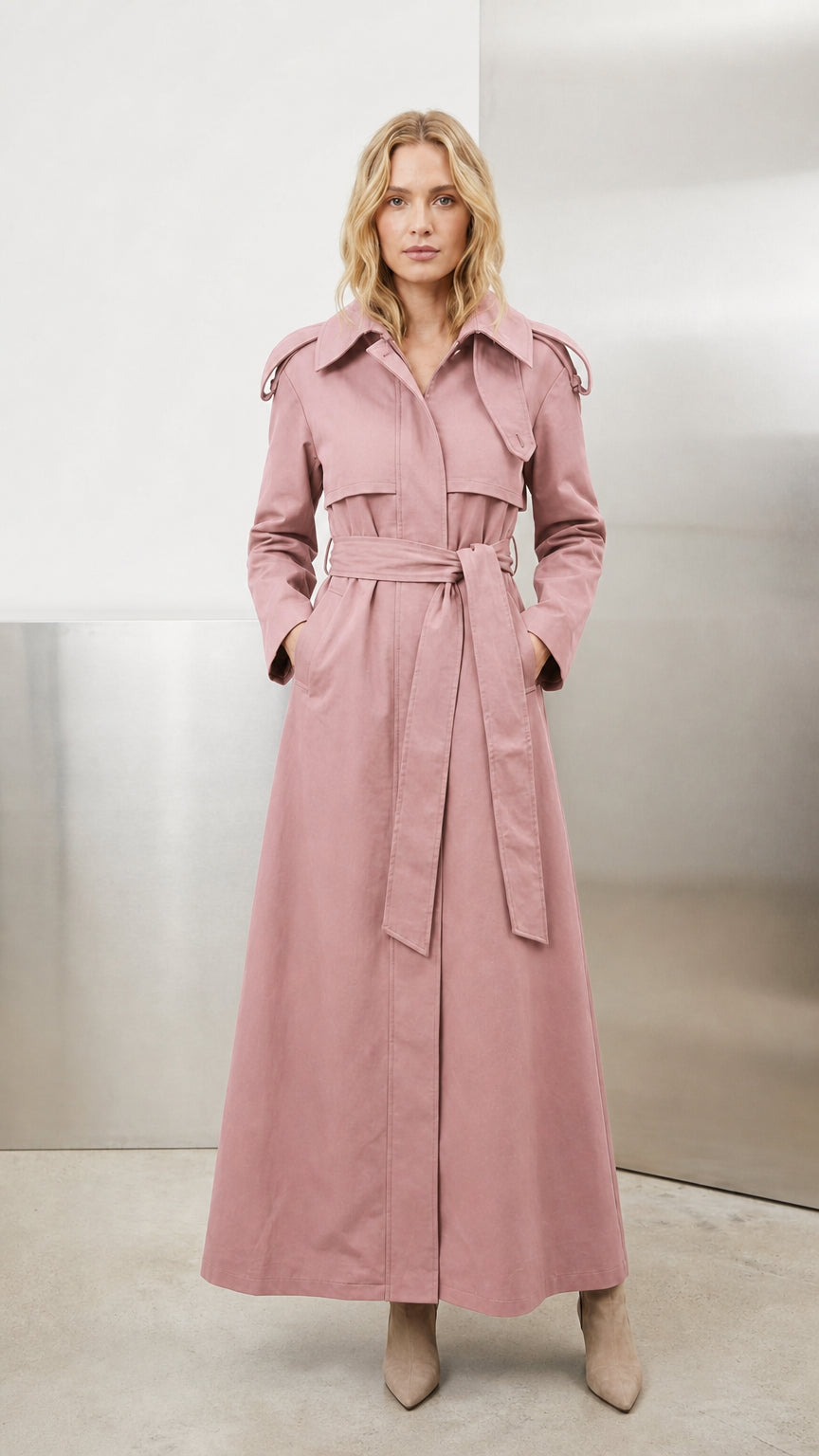 Model wearing soft dusty pink belted maxi trench coat