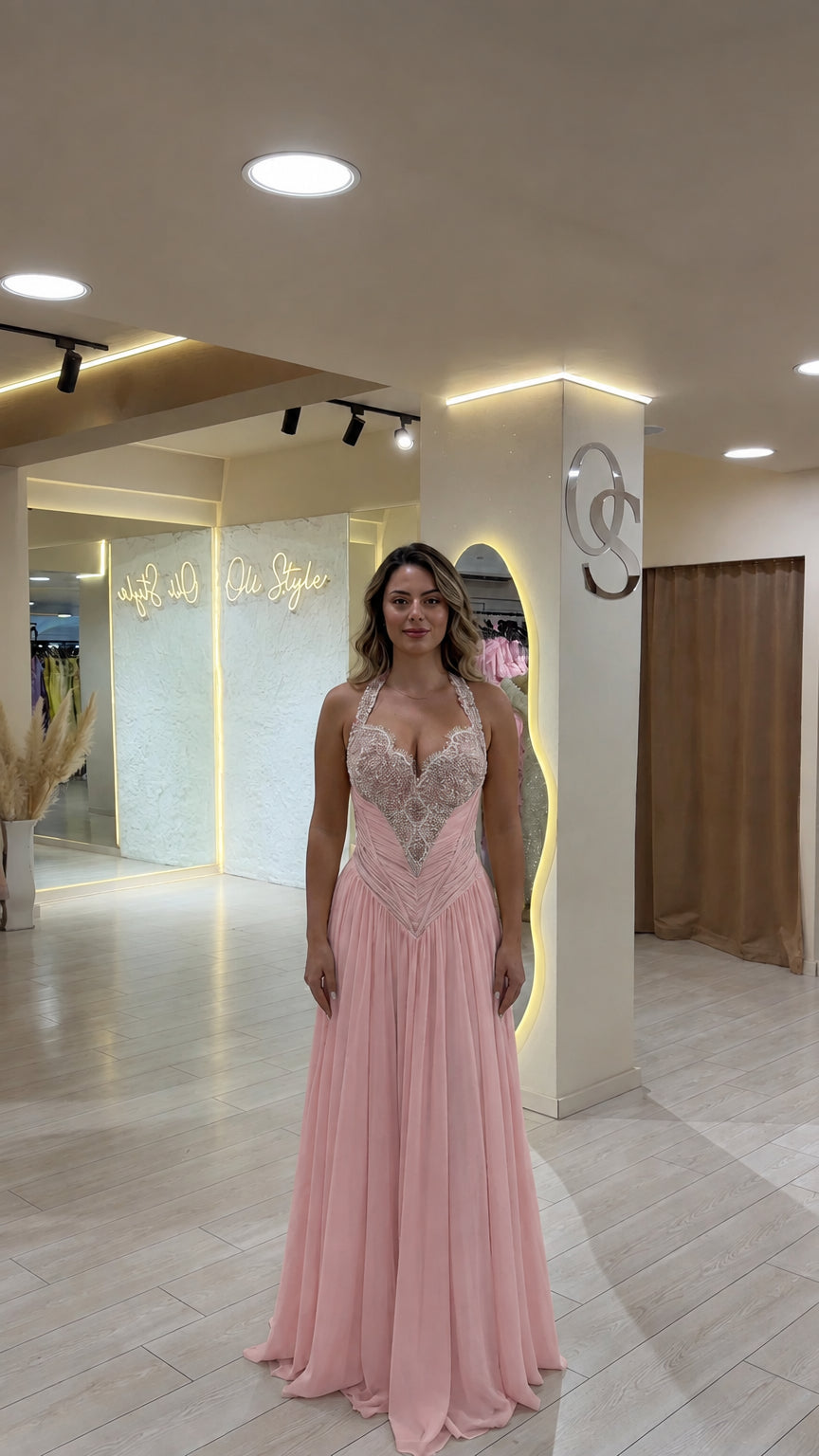 Model wearing soft blush pink halter embellished formal maxi gown