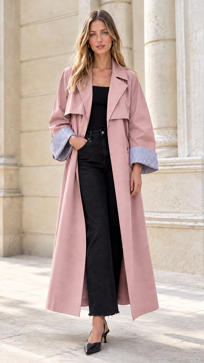 Model wearing dusty pink longline trench coat with striped turn-back cuffs