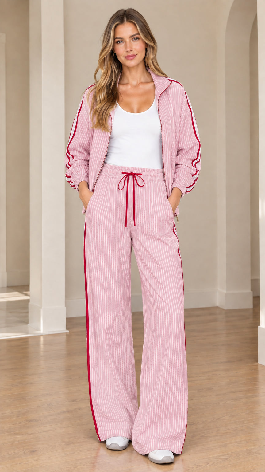 Model wearing pink striped track jacket and matching wide-leg lounge pants