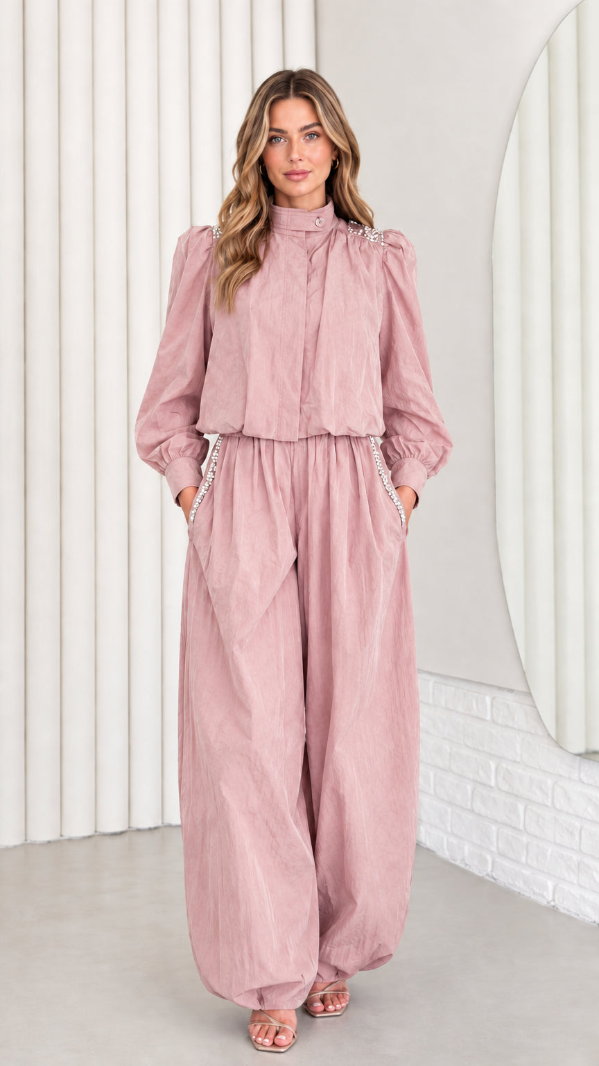 Front view of model wearing dusty pink rhinestone balloon leg jumpsuit