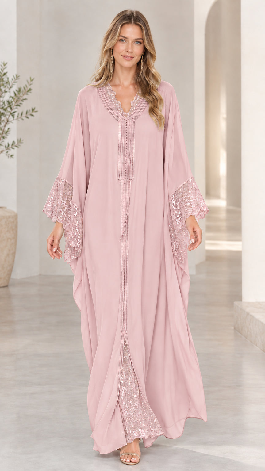 Model wearing dusty pink lace-trimmed flowing caftan dress