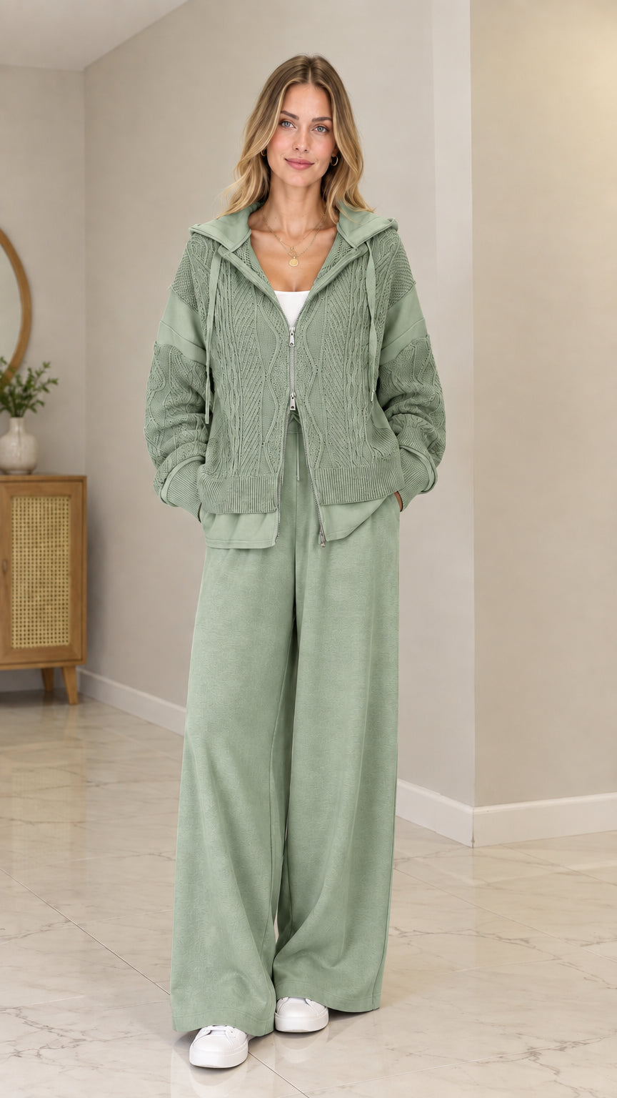 Front view of model wearing Sage Green cable-knit zip-up hooded cardigan set