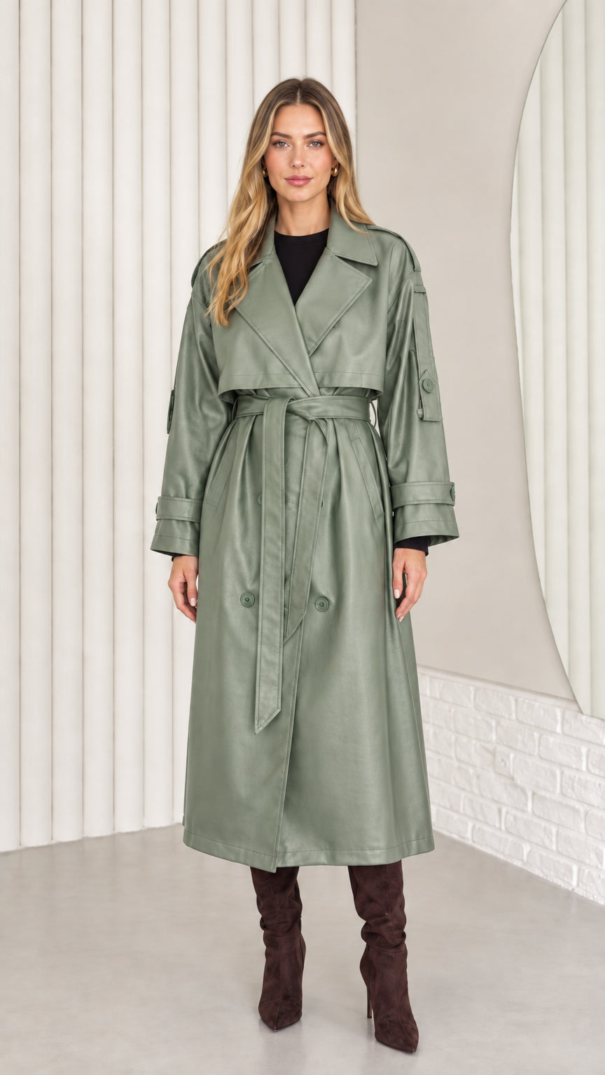 Full-length front view of woman wearing sage green faux leather belted trench coat