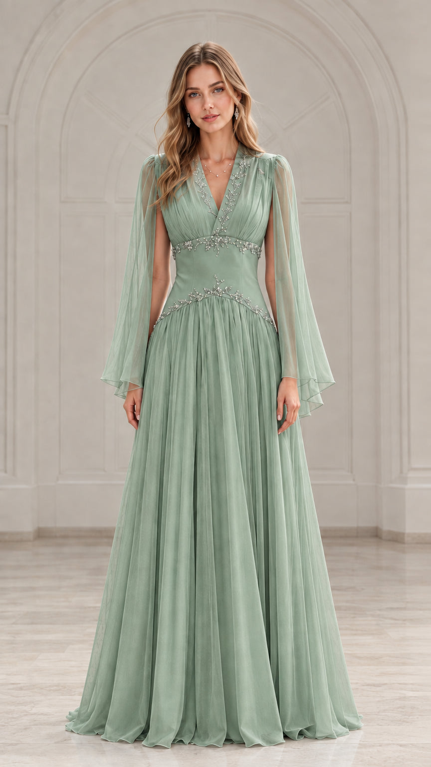 Front view of model wearing a sage green beaded V-neck evening gown with cape sleeves