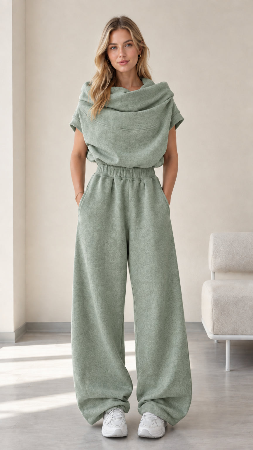 Full-length studio view of model wearing sage green cowl neck top and wide-leg pants set