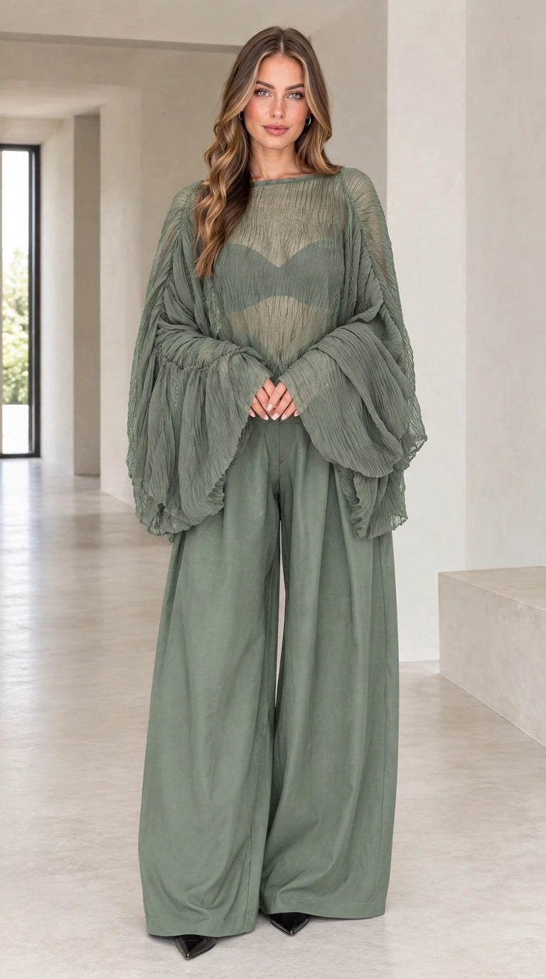 Front view of woman wearing sage green sheer pleated bell sleeve top and wide-leg pants set