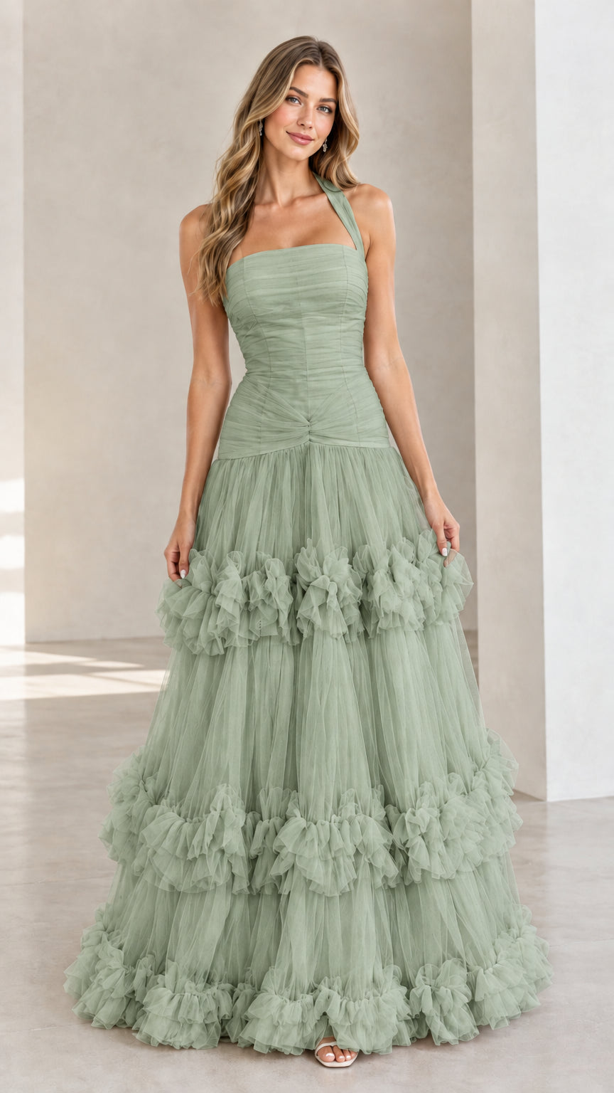Front view of woman wearing Sage Green halter neck tiered tulle ruffle gown