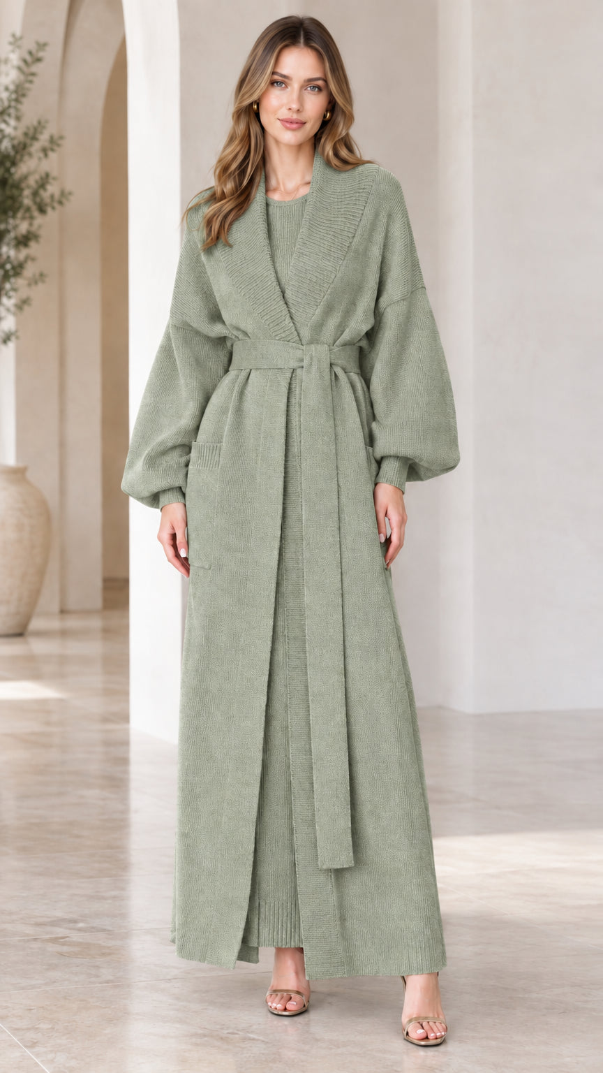 Full-length view of woman wearing sage green longline knit cardigan and dress set