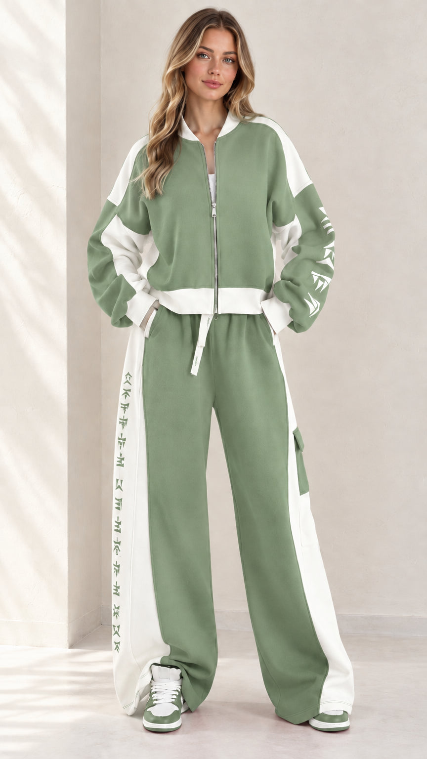 Full front view of model wearing sage green and white colorblock zip-up tracksuit set
