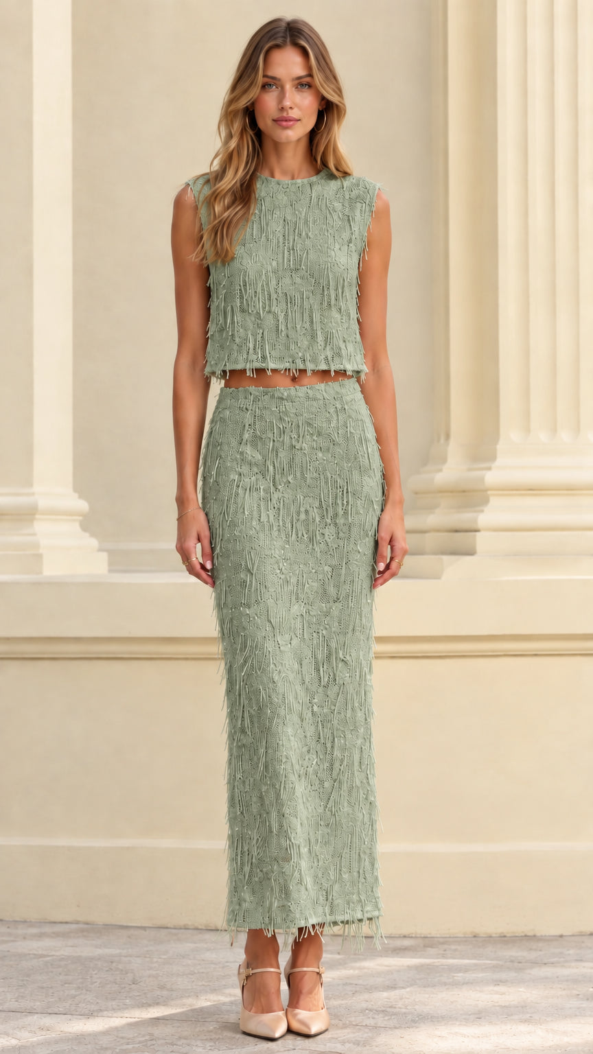 Front full view of woman wearing sage green textured fringe crop top and maxi skirt set
