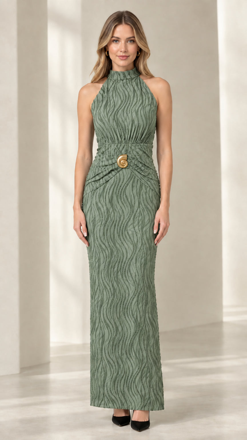 Front view of woman wearing sage green textured column maxi dress with brooch