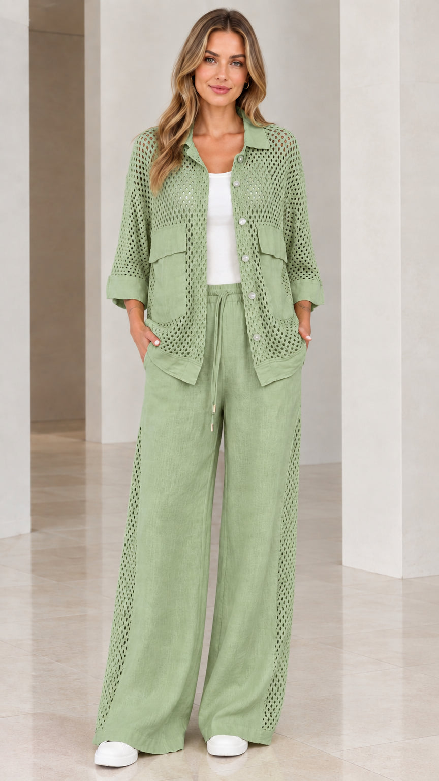 Full front view of woman wearing sage green open knit shirt and wide-leg pants set