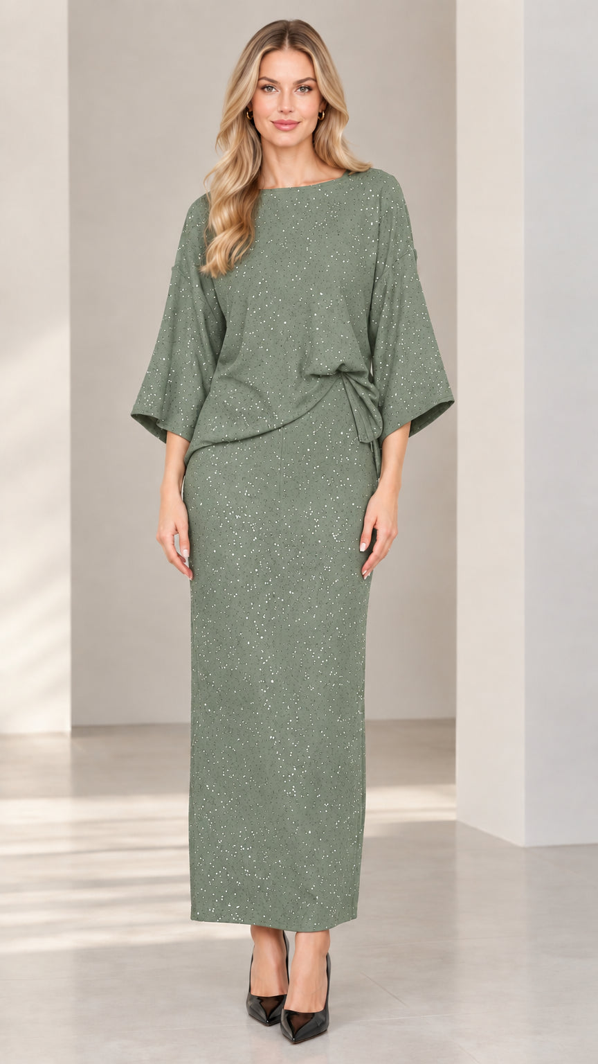 Full-length studio shot of woman modeling sage green glitter two-piece maxi skirt set