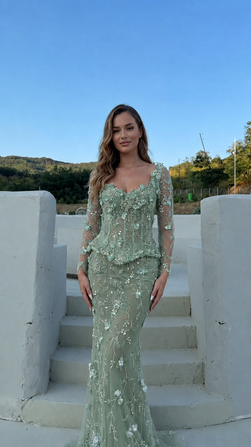 Model wearing the floral appliqué corset peplum evening gown in sage green